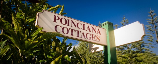 Poinciana Cottages sign